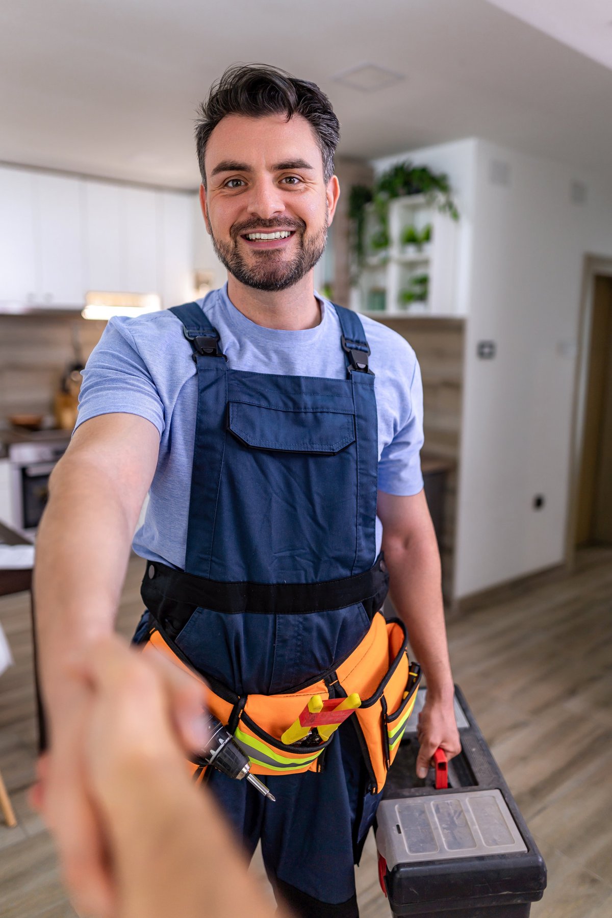 Plumber installing pipework in a home